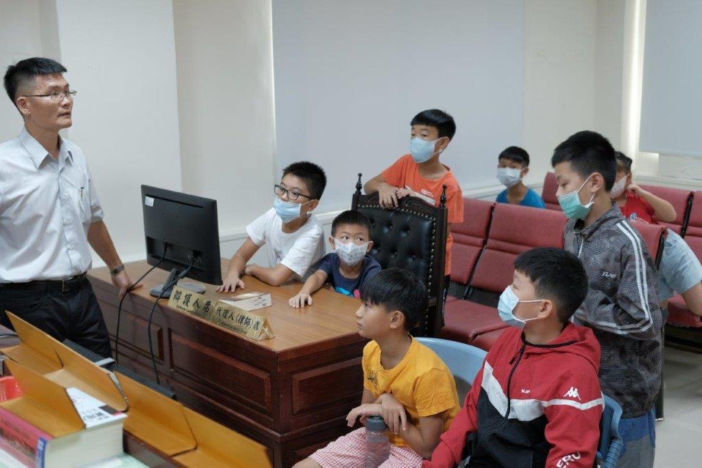 李主任檢察官為小朋友介紹偵察庭配置